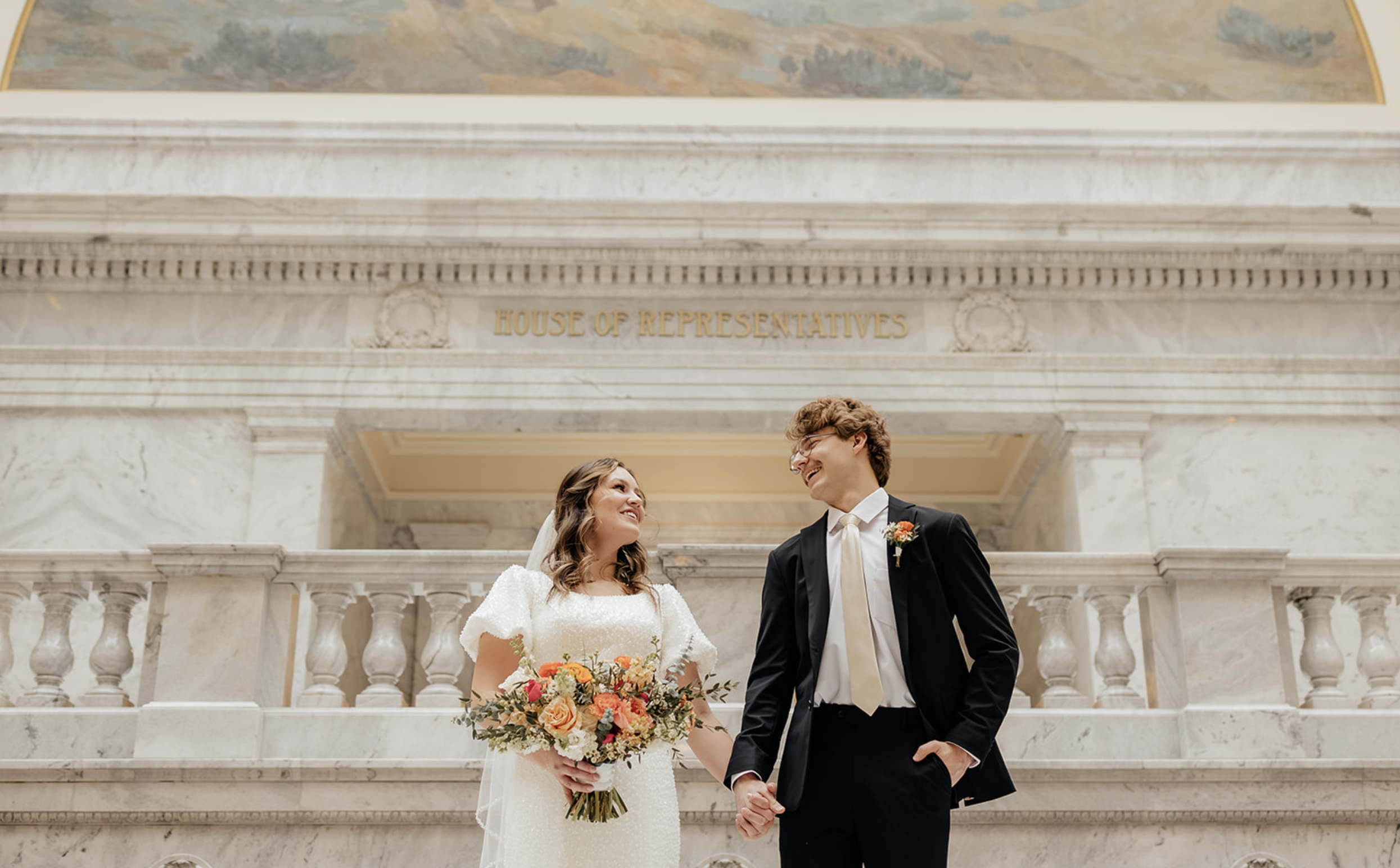wedding attire couple in classy building for winter bridals
