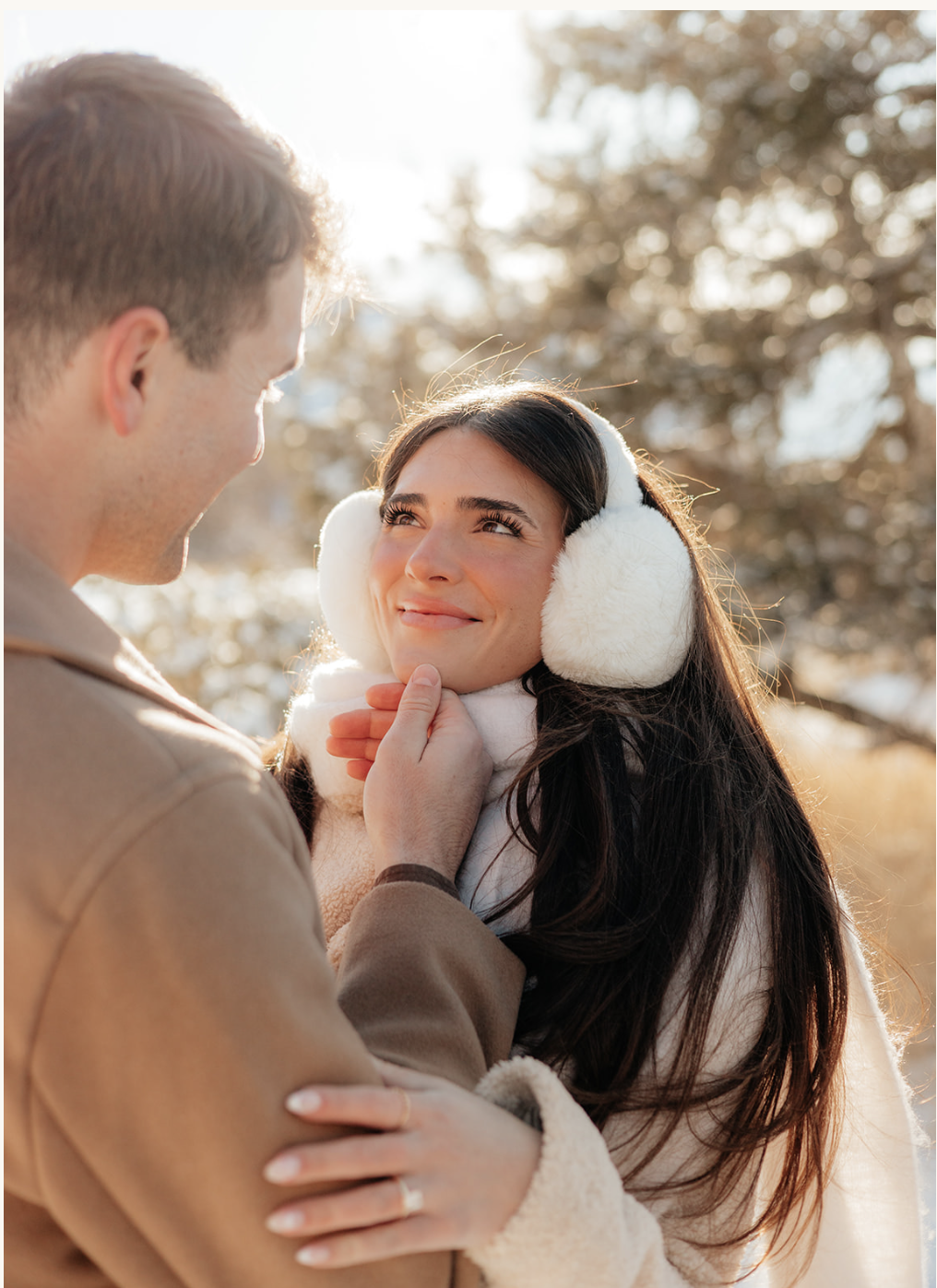 winter couple holding hands outdoors in snowy weather